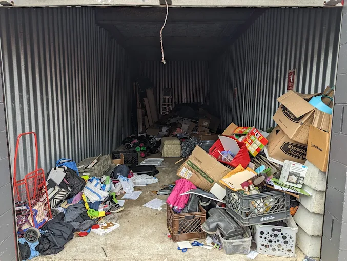 Packed storage container full of junk before cleanout