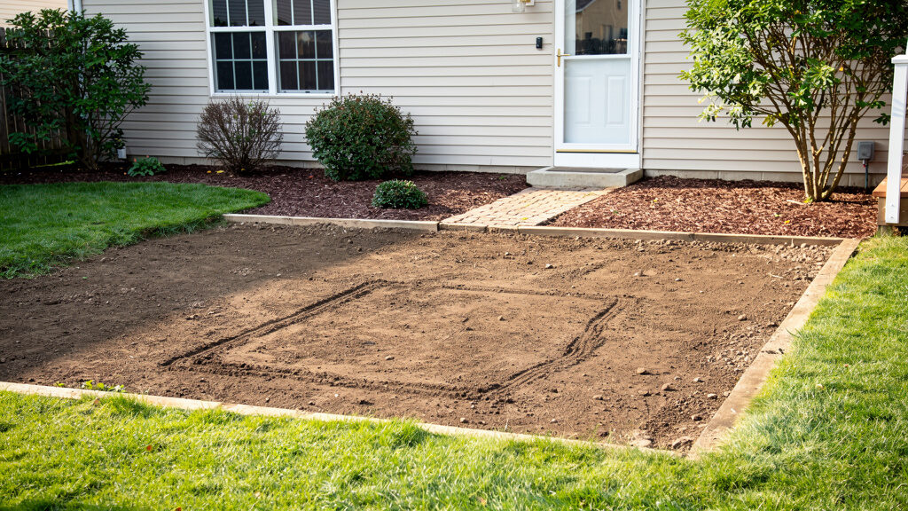 Cleared yard area ready for new construction after deck demolition