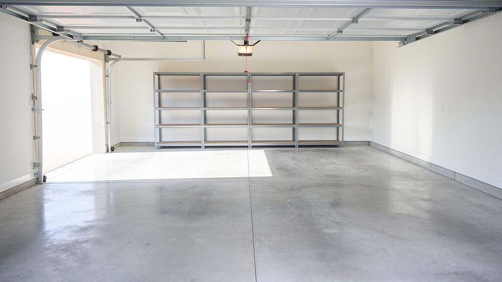 Empty, clean garage after professional cleanout showing open storage space